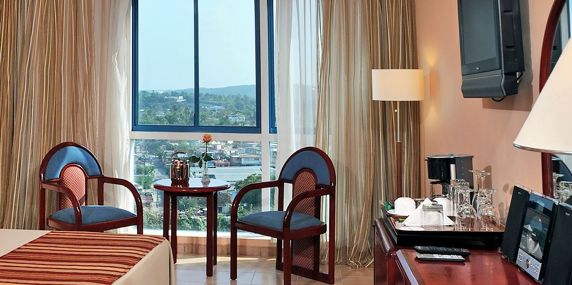 a room with a desk and chairs