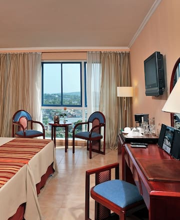 a room with a desk and chairs