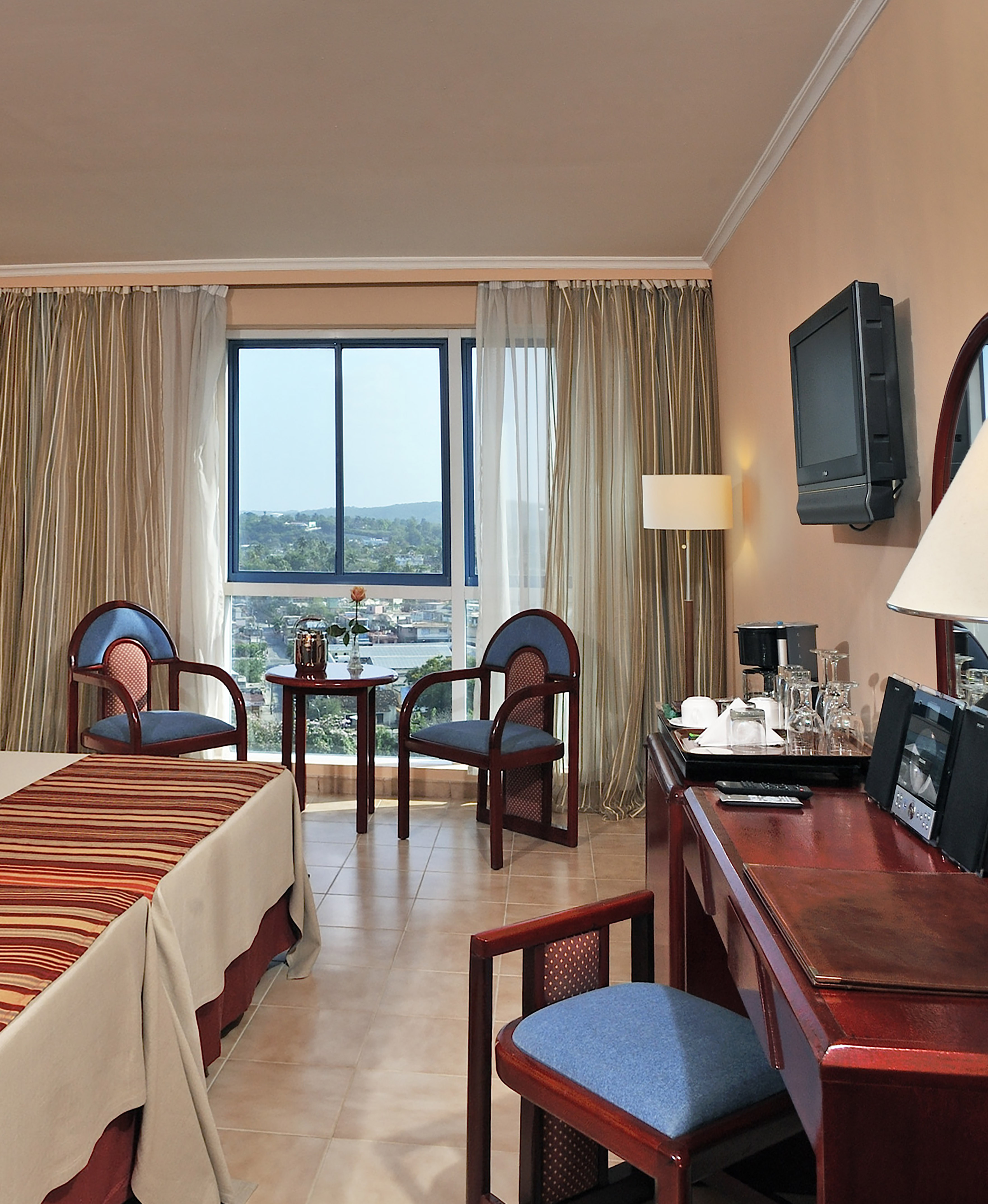 a room with a desk and chairs