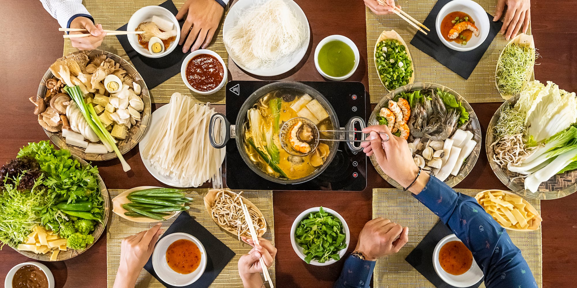 a group of people eating food at a table