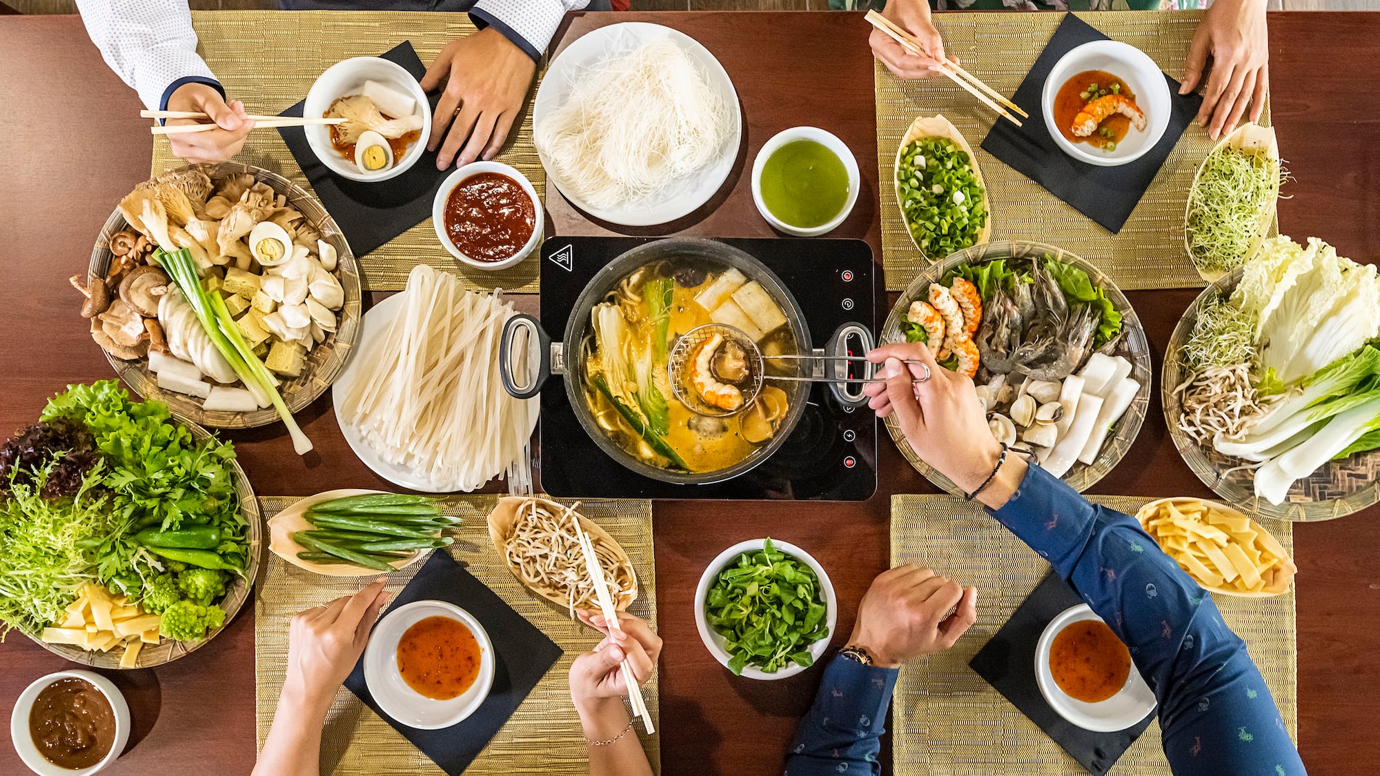 a group of people eating food at a table
