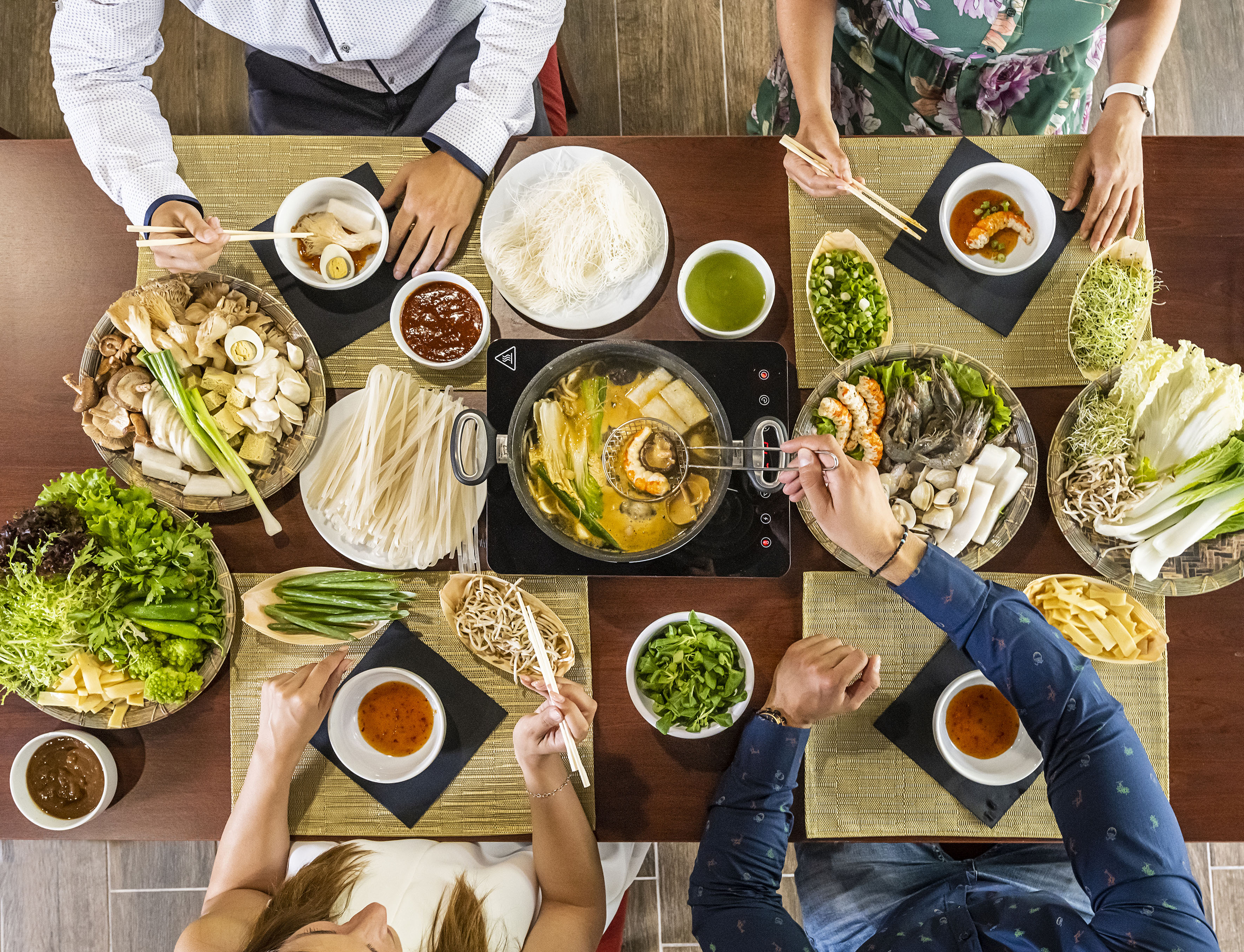 a group of people eating food at a table
