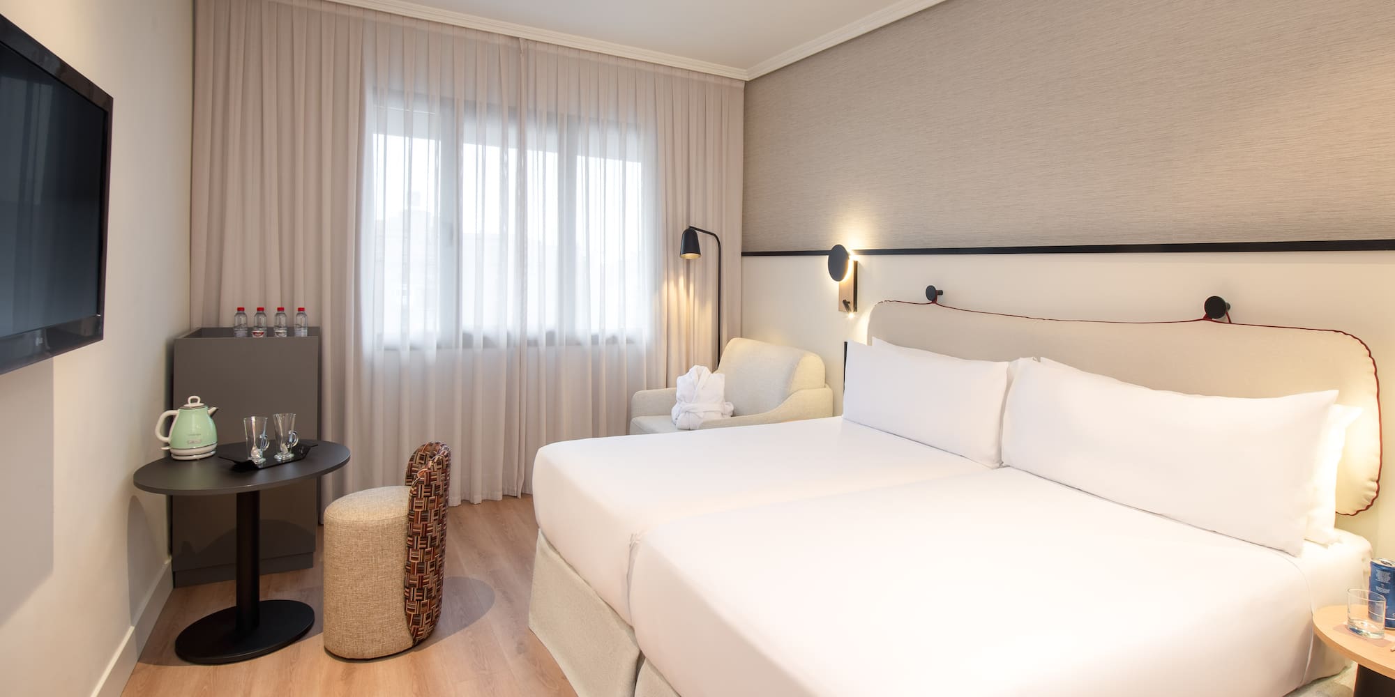 a room with two beds and a table