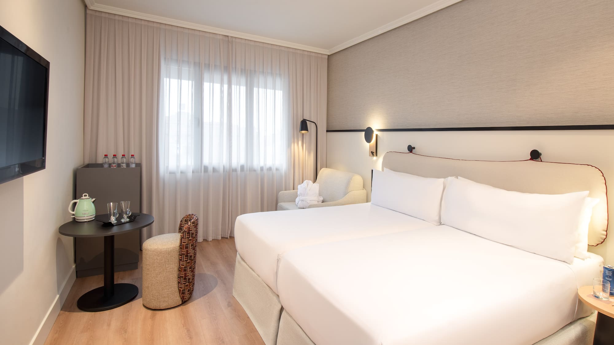 a room with two beds and a table