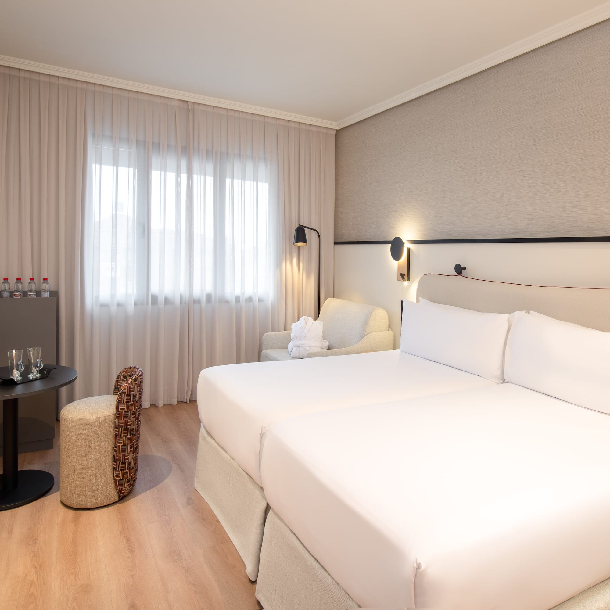 a room with two beds and a table