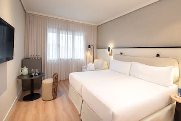 a room with two beds and a table