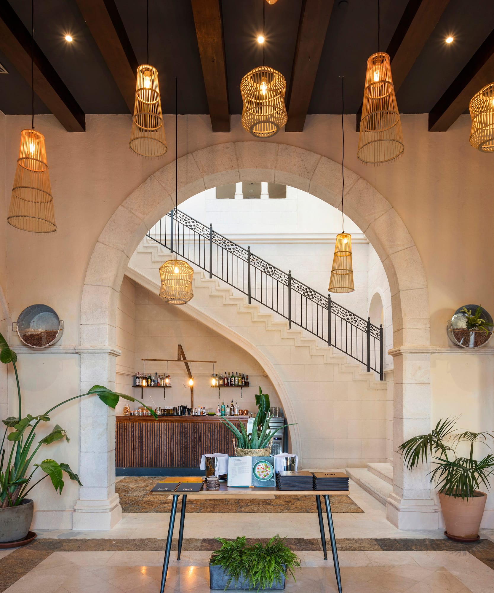 a room with a staircase and a bar