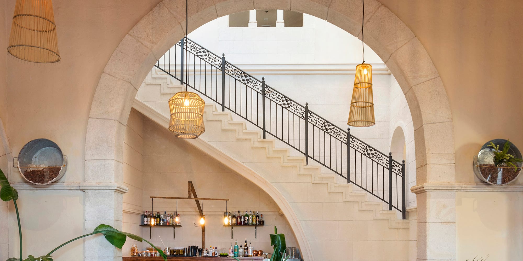 a room with a staircase and a bar