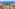 Aerial view: Mediterranean coastal resort, sea, islands, hotels, and villas.