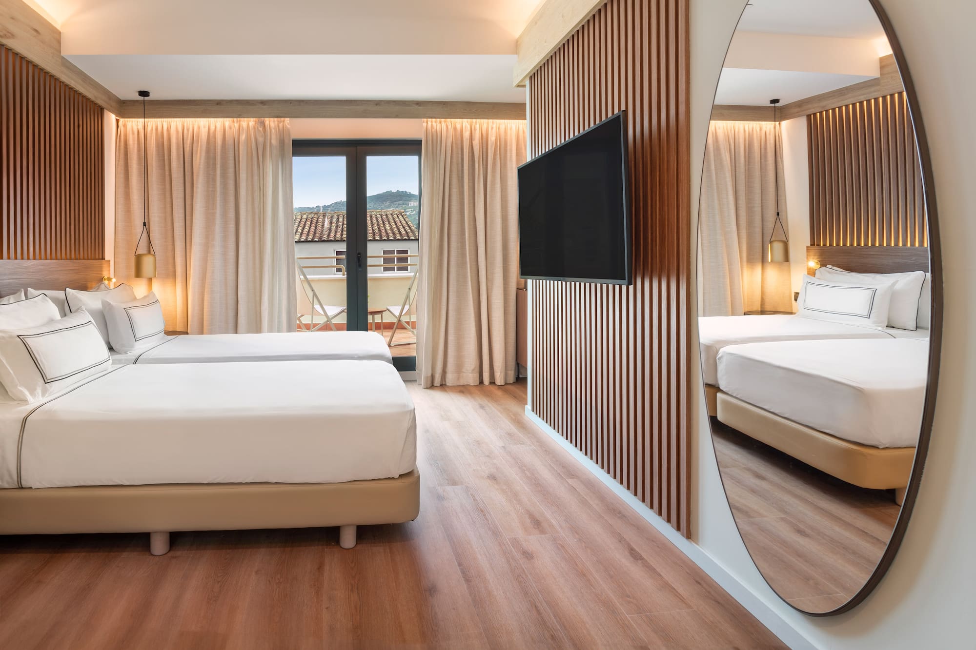 a room with a mirror and a bed