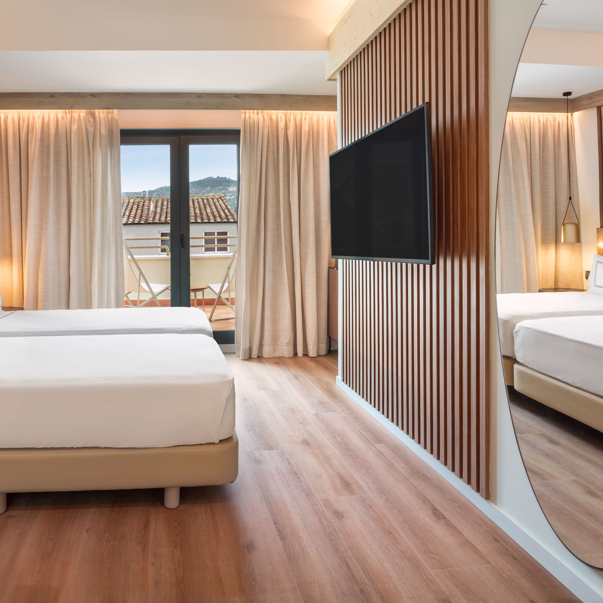 a room with a mirror and a bed