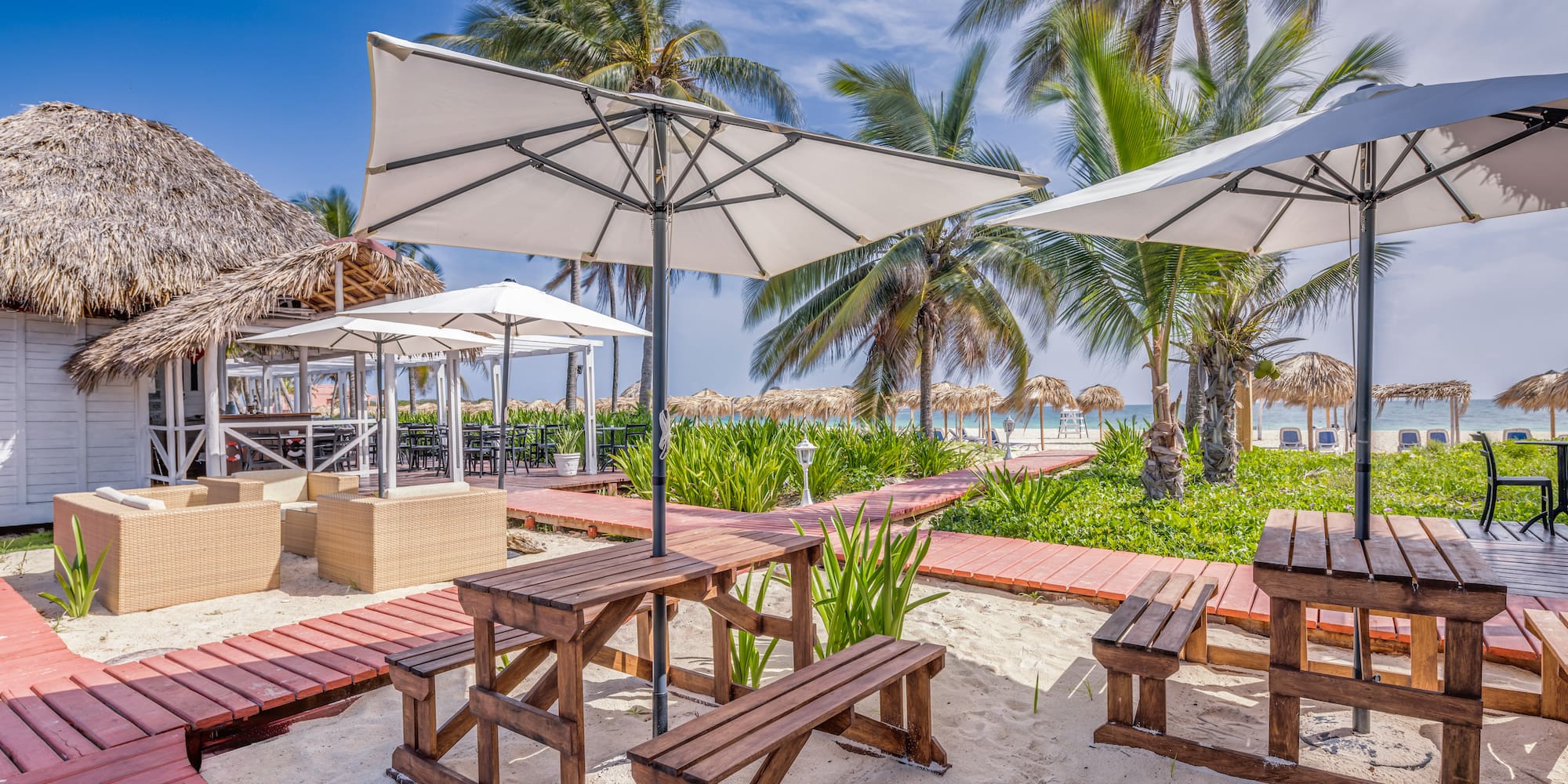 a picnic tables and umbrellas on a beach