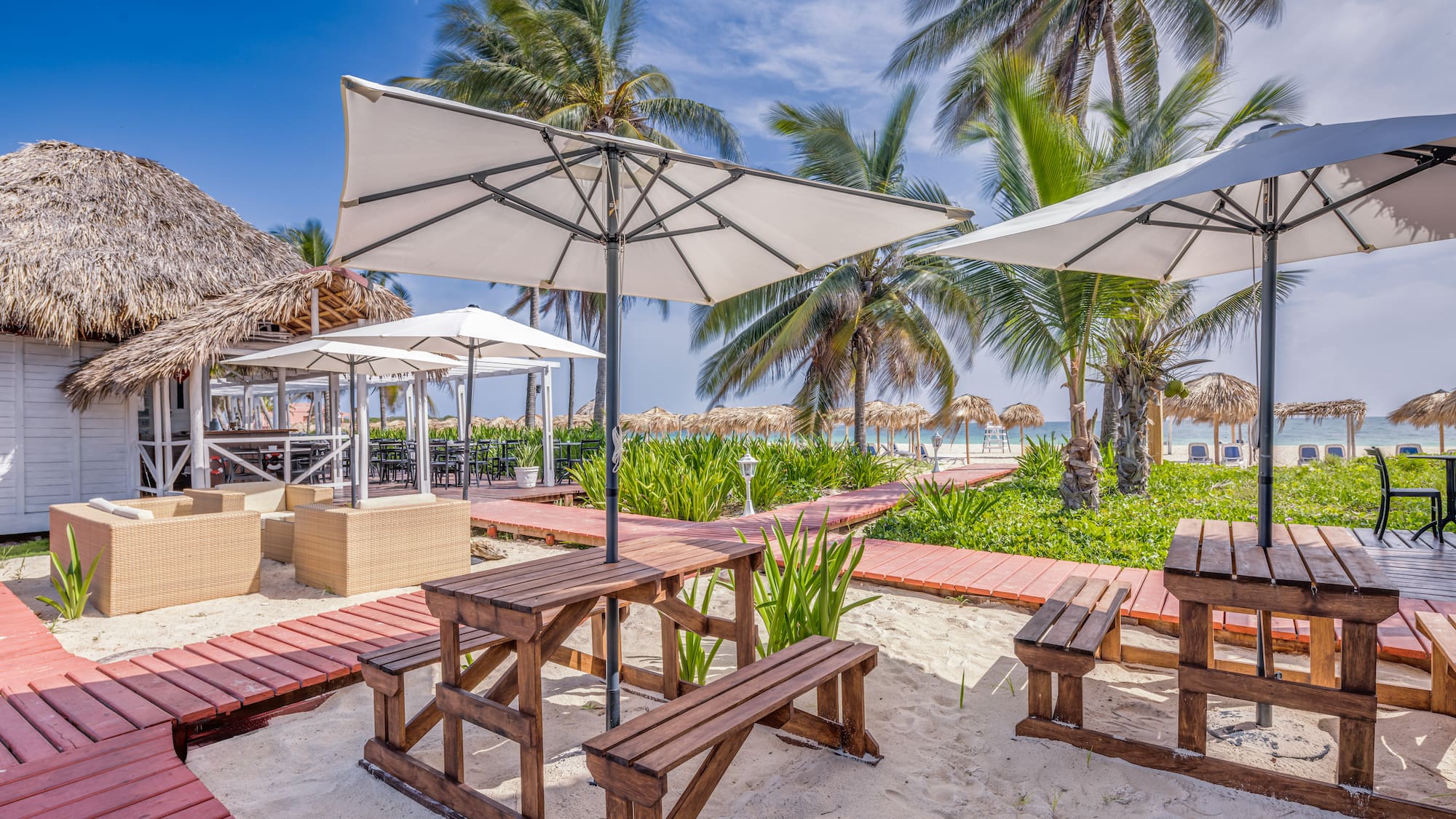a picnic tables and umbrellas on a beach