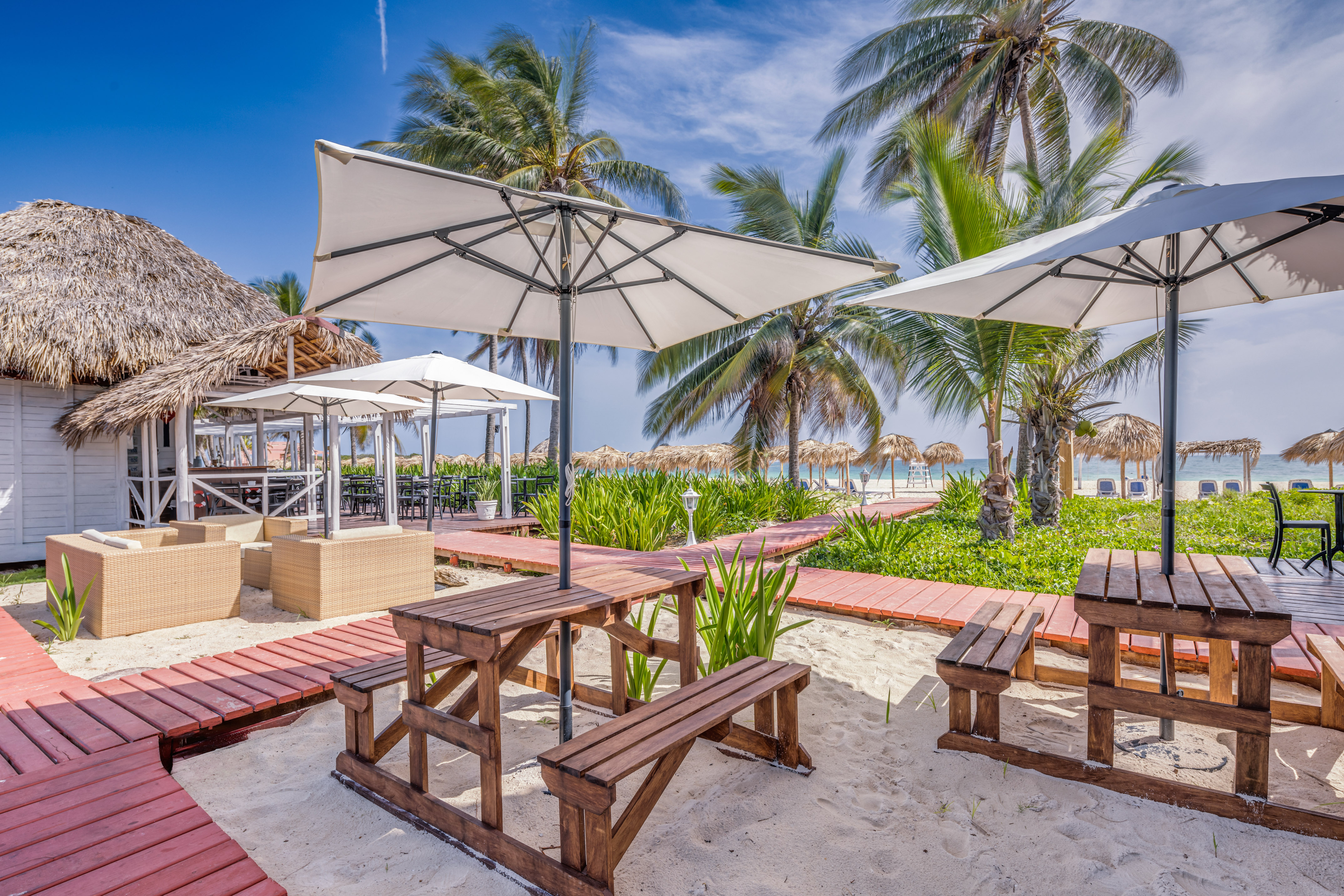 a picnic tables and umbrellas on a beach