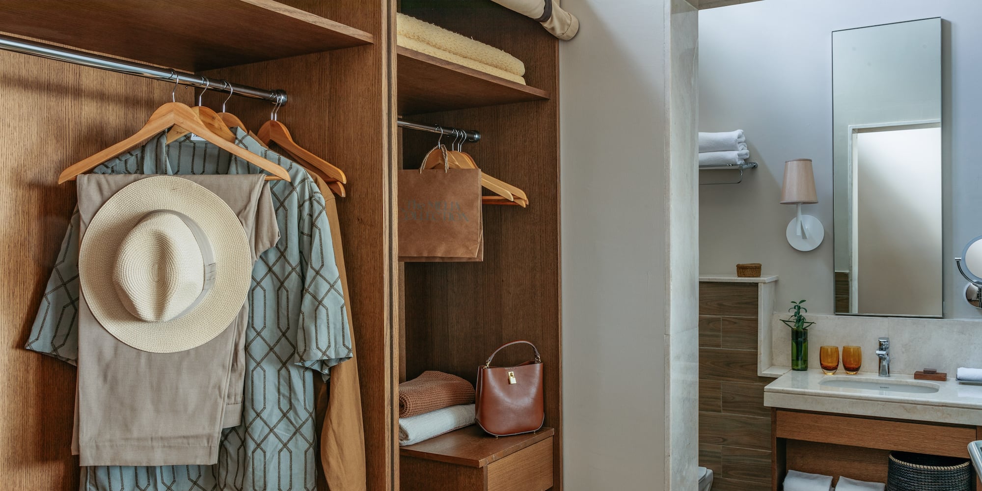 a closet with clothes on swingers and a towel