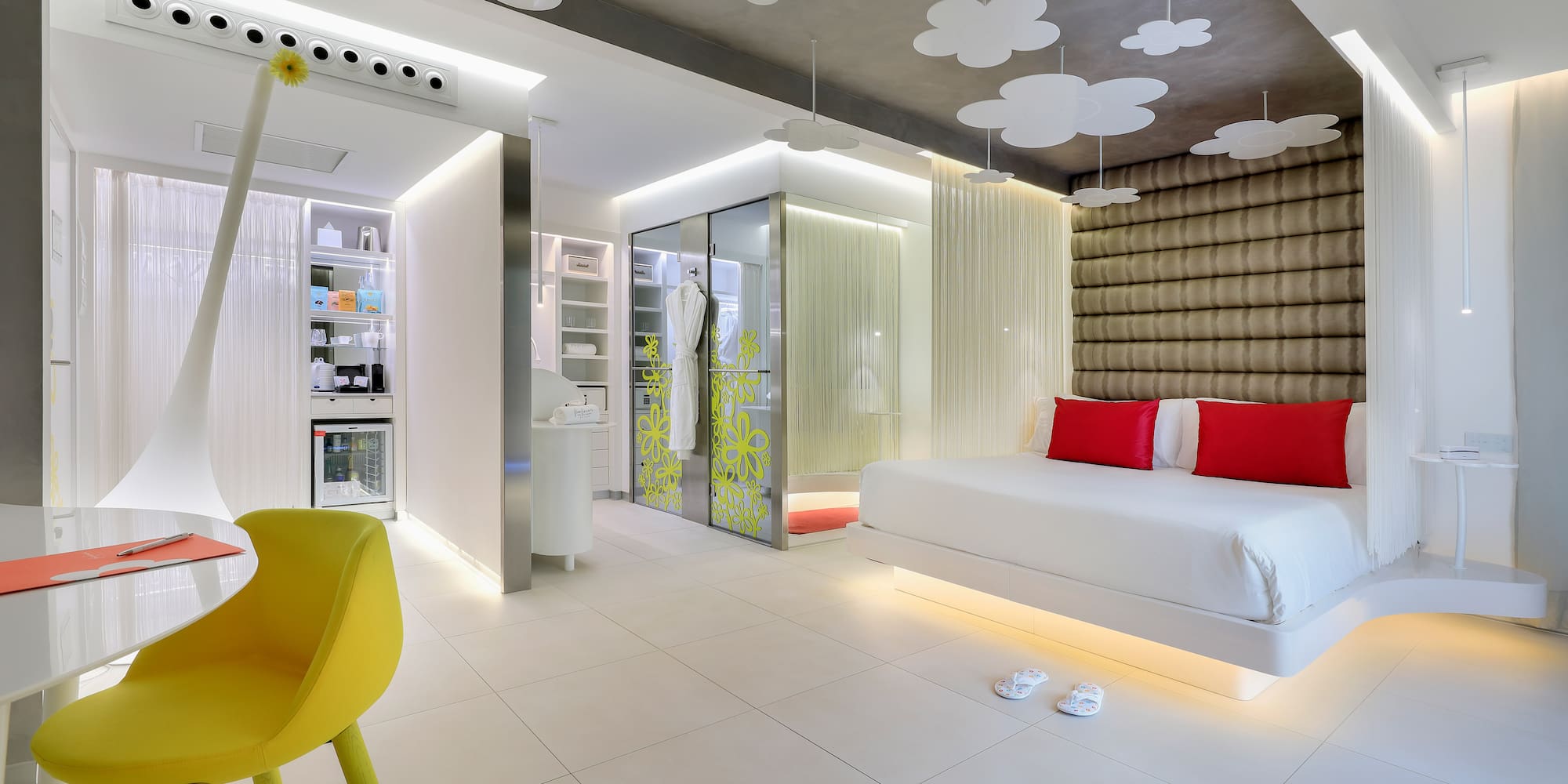 a room with a bed and a yellow chair