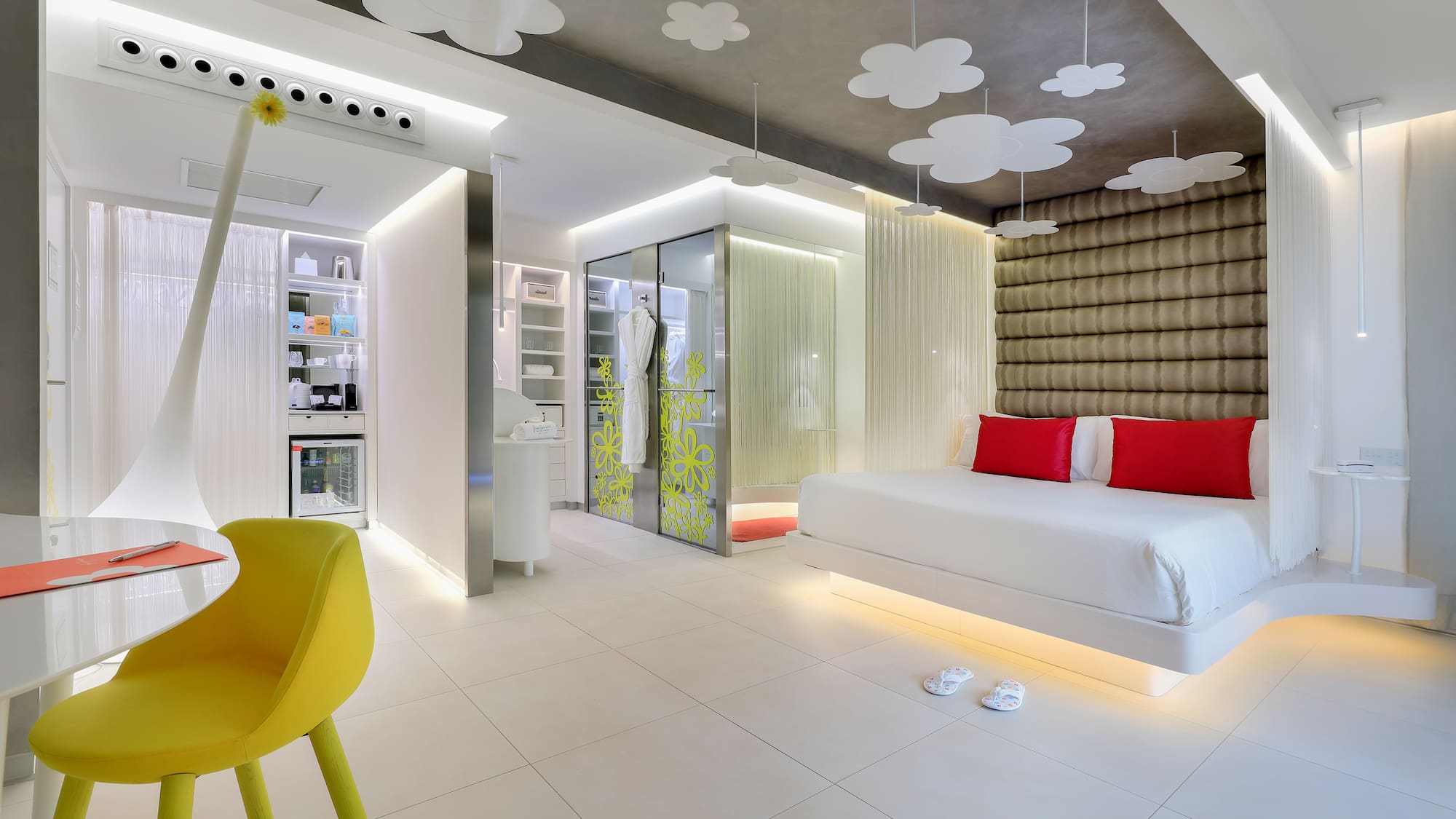 a room with a bed and a yellow chair