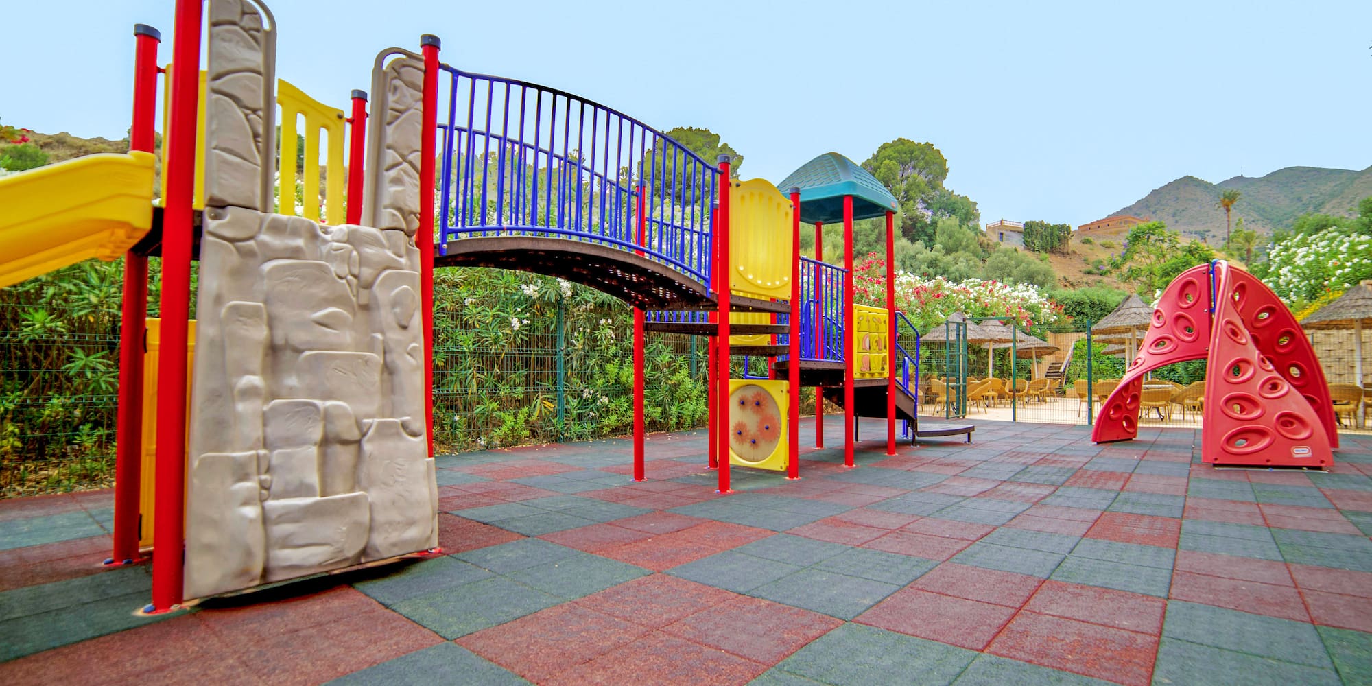 a playground with a bridge and slide
