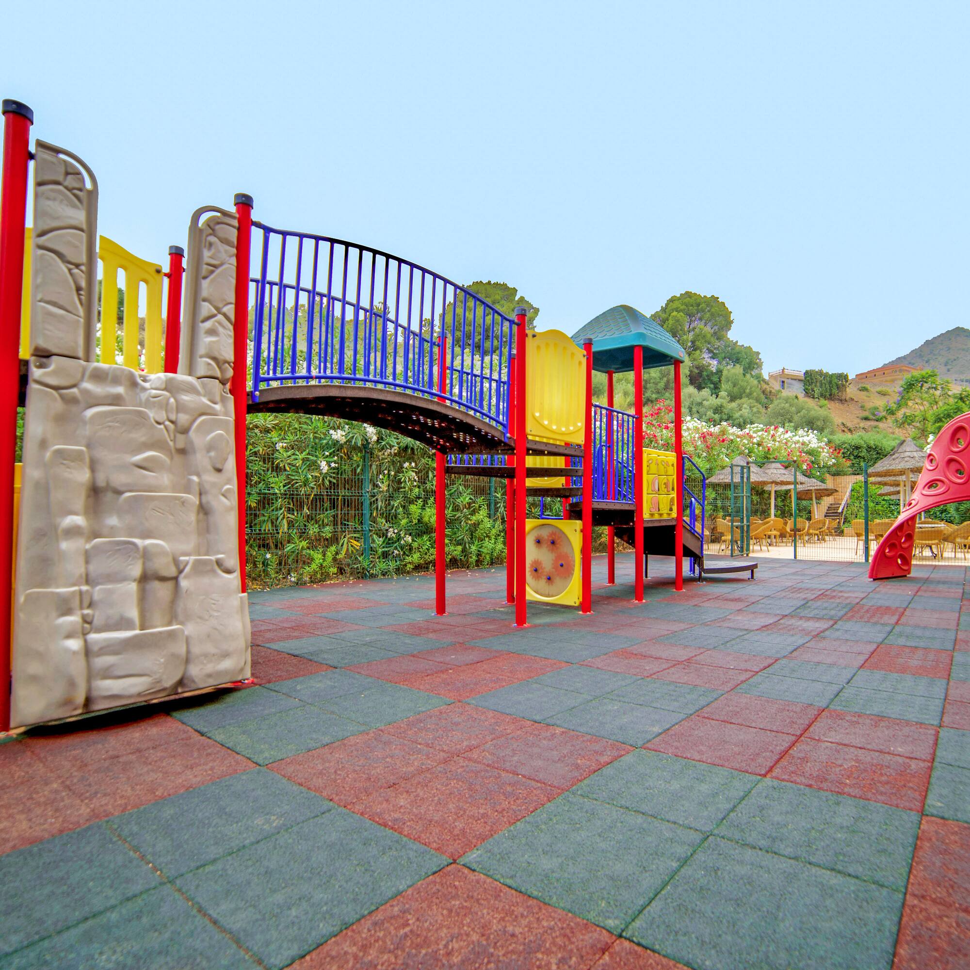 a playground with a bridge and slide