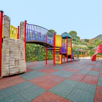 a playground with a bridge and slide