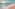 a beach with waves and a sunset