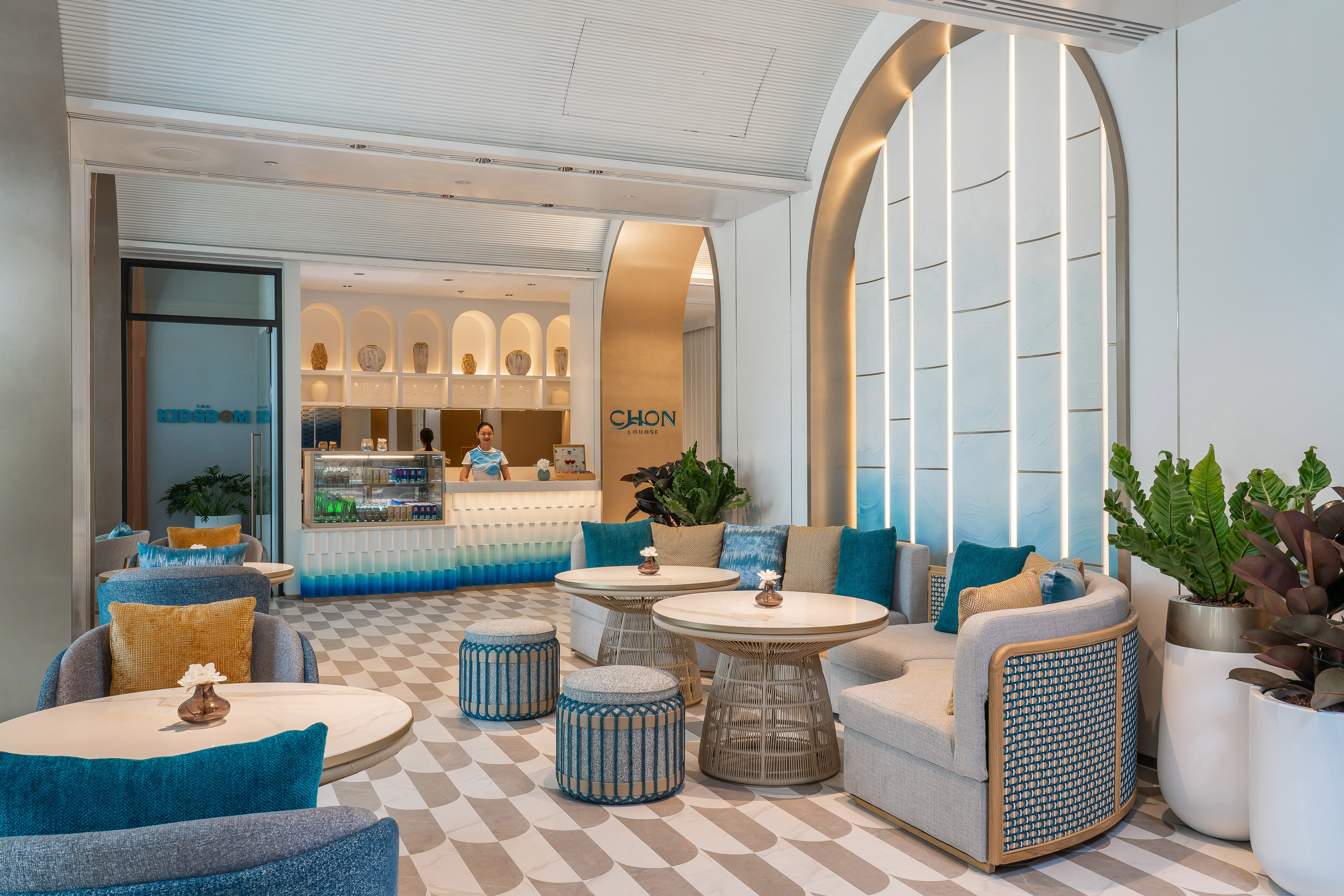 Modern Chon Lounge with blue/gray seating, counter, and elegant design.