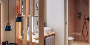 a bathroom with a wood partition