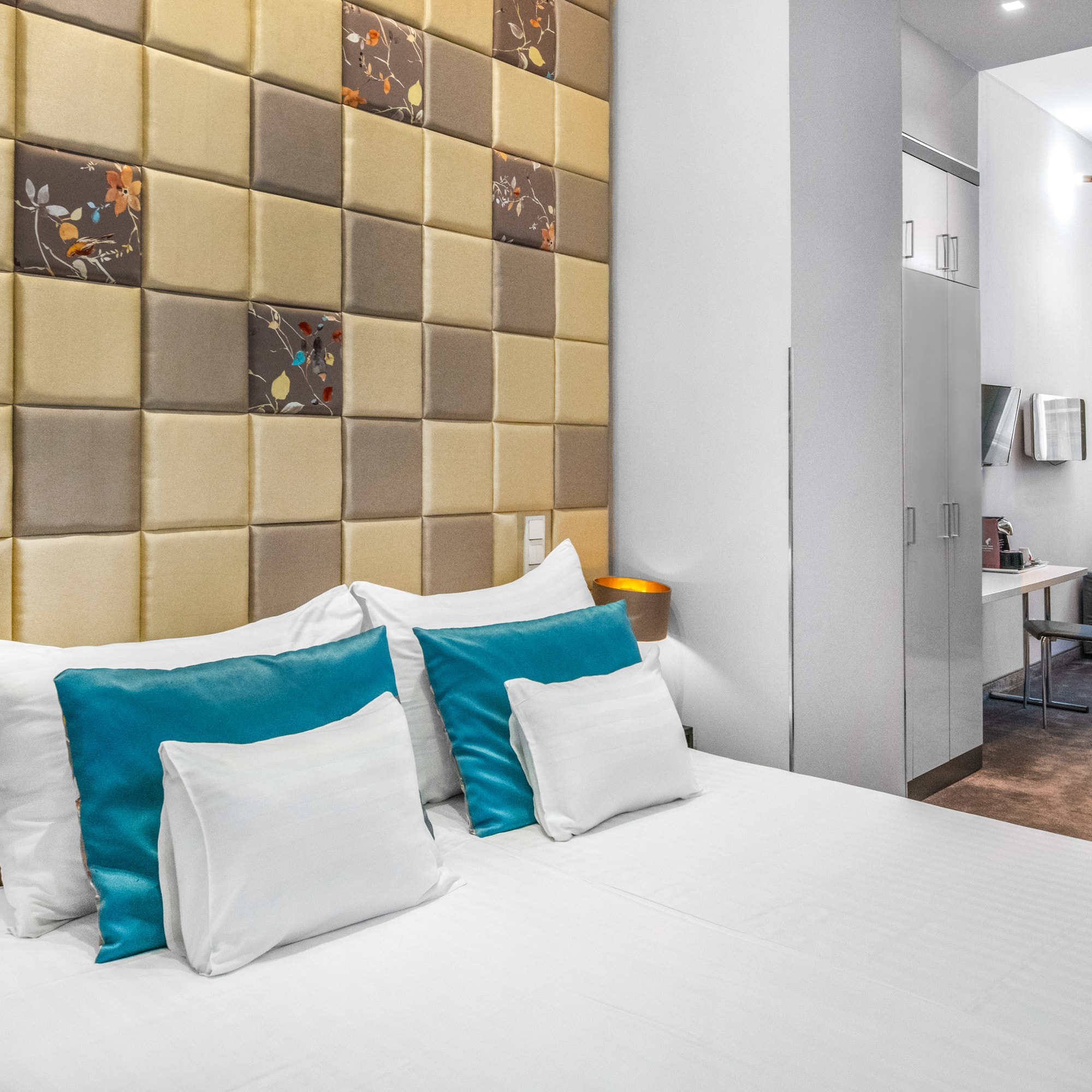 a bed with pillows in a room