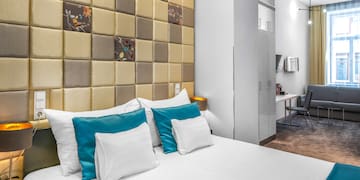 a bed with pillows in a room