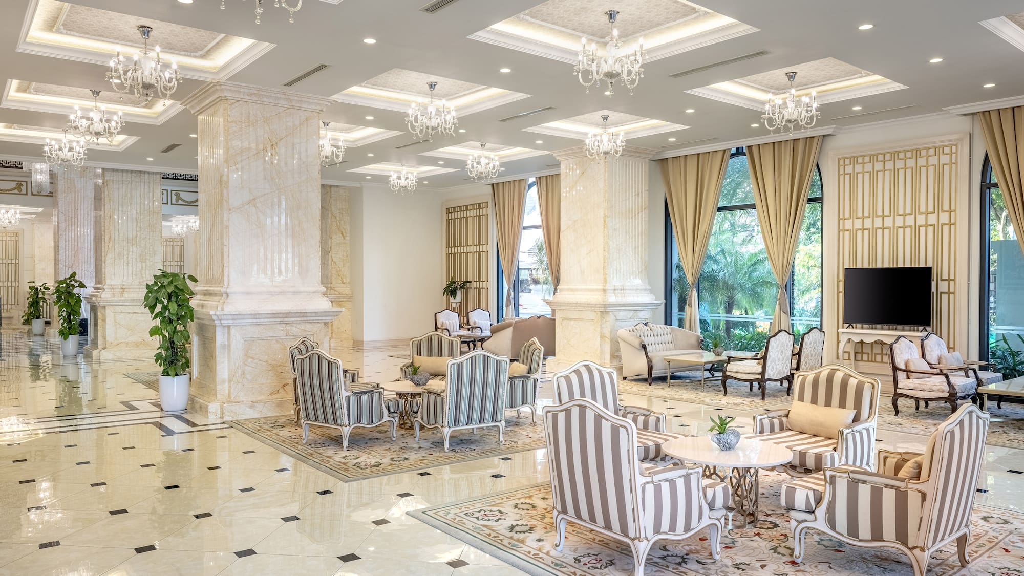 a room with a large chandelier and chairs
