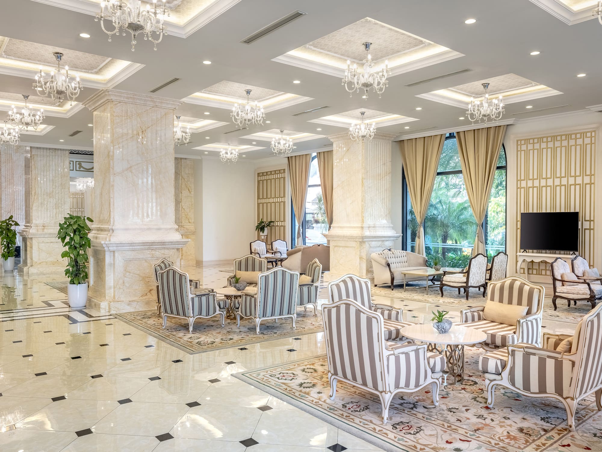 a room with a large chandelier and chairs