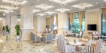 a room with a large chandelier and chairs