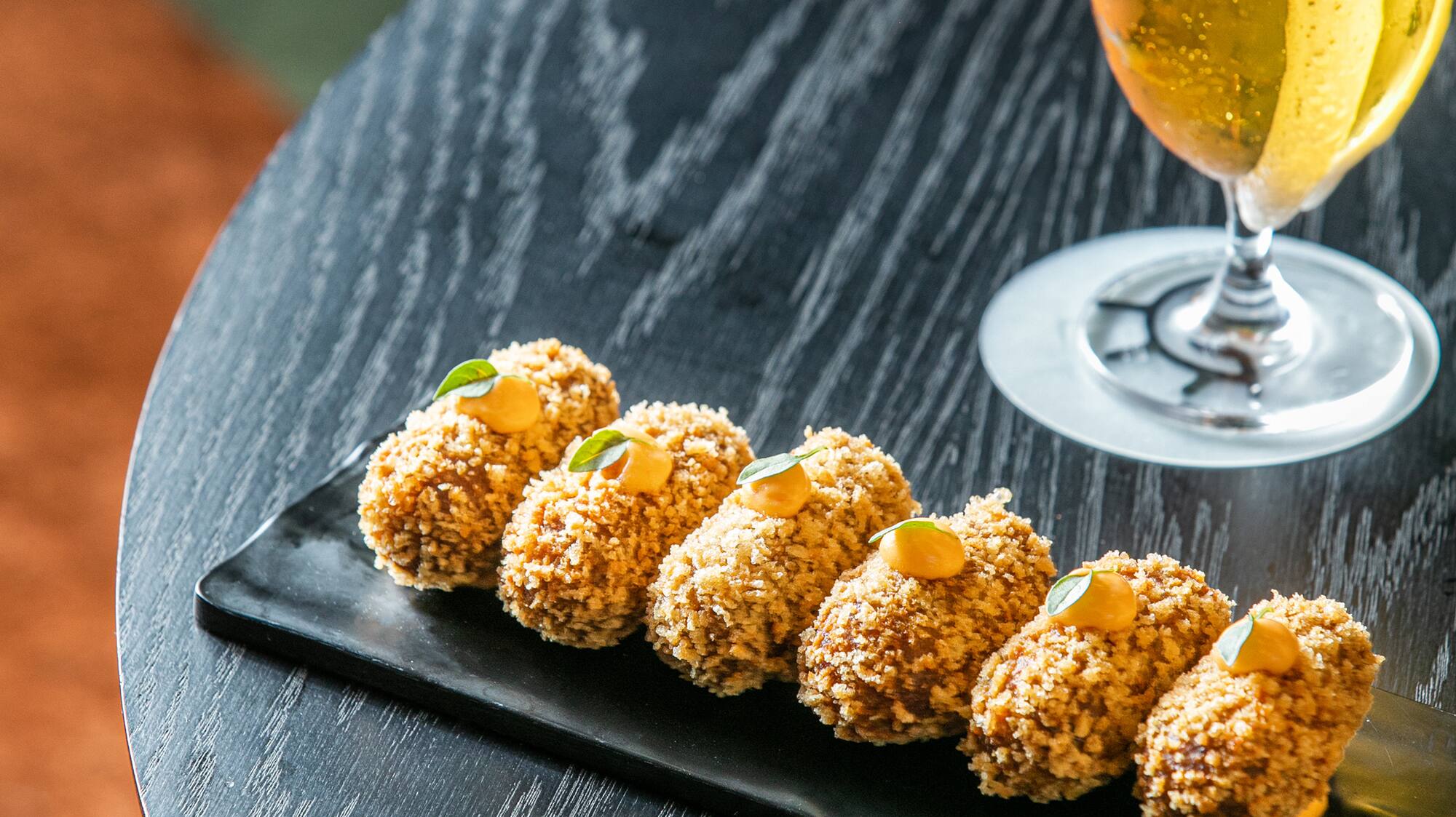 food on a plate next to a glass of beer