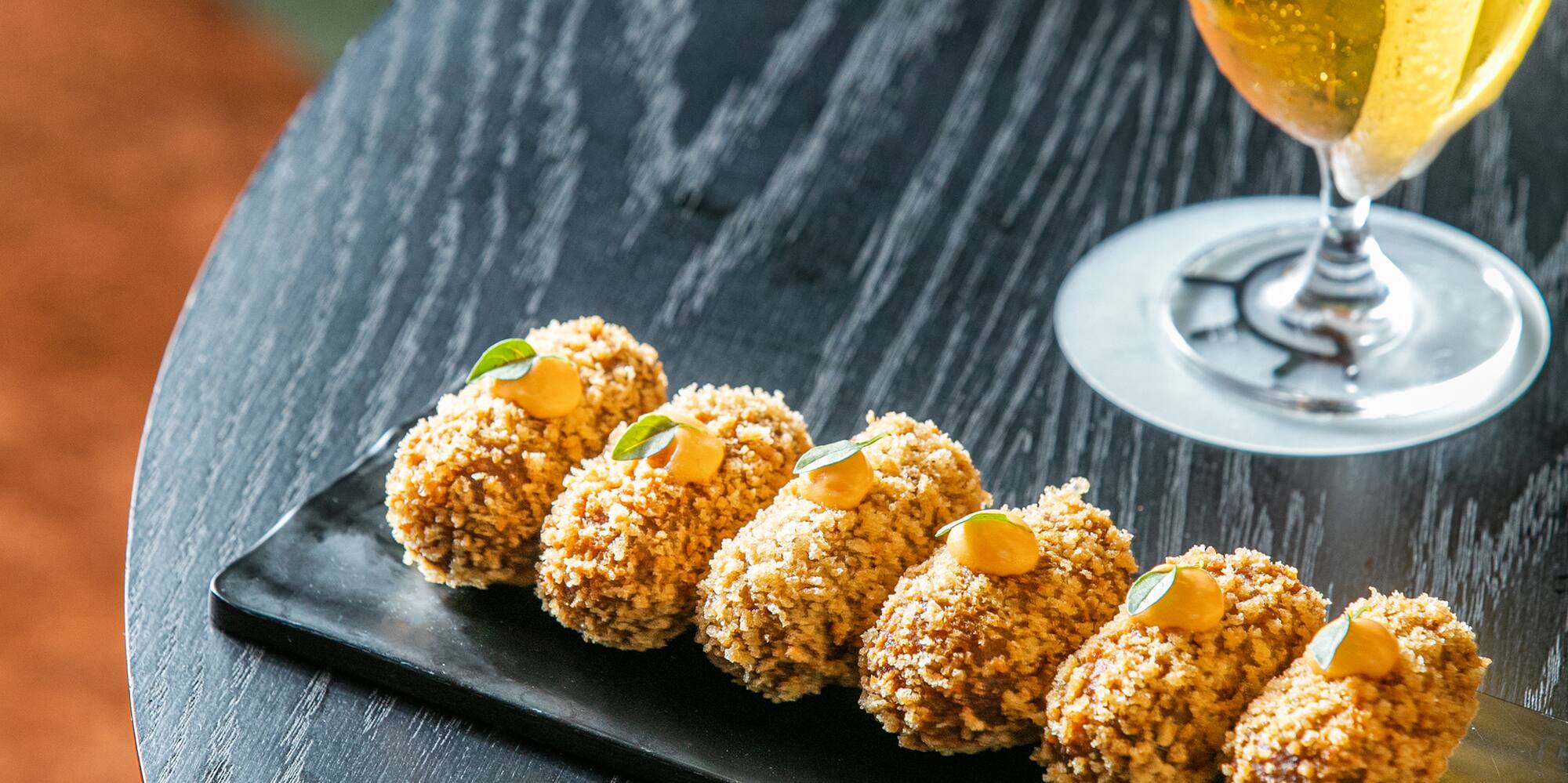 food on a plate next to a glass of beer