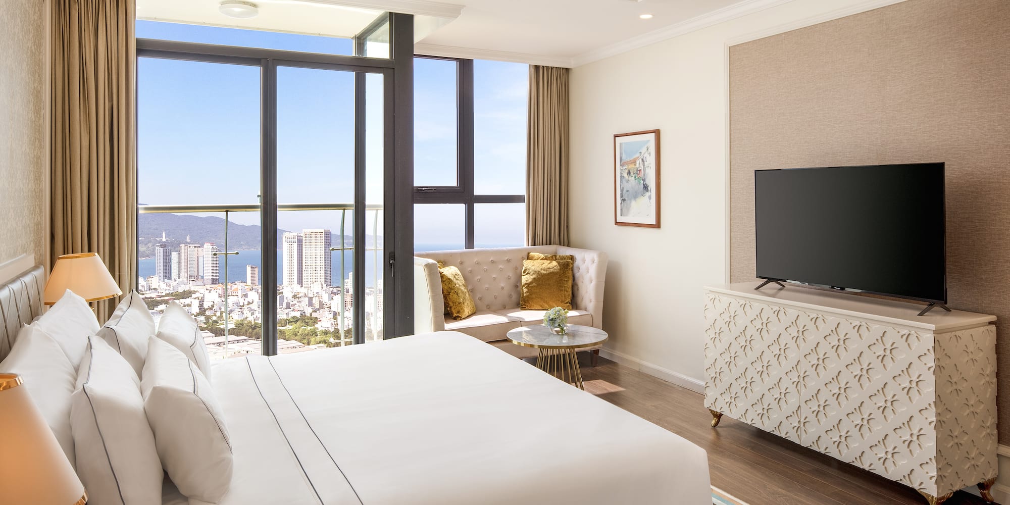 a bedroom with a television and a view of the city