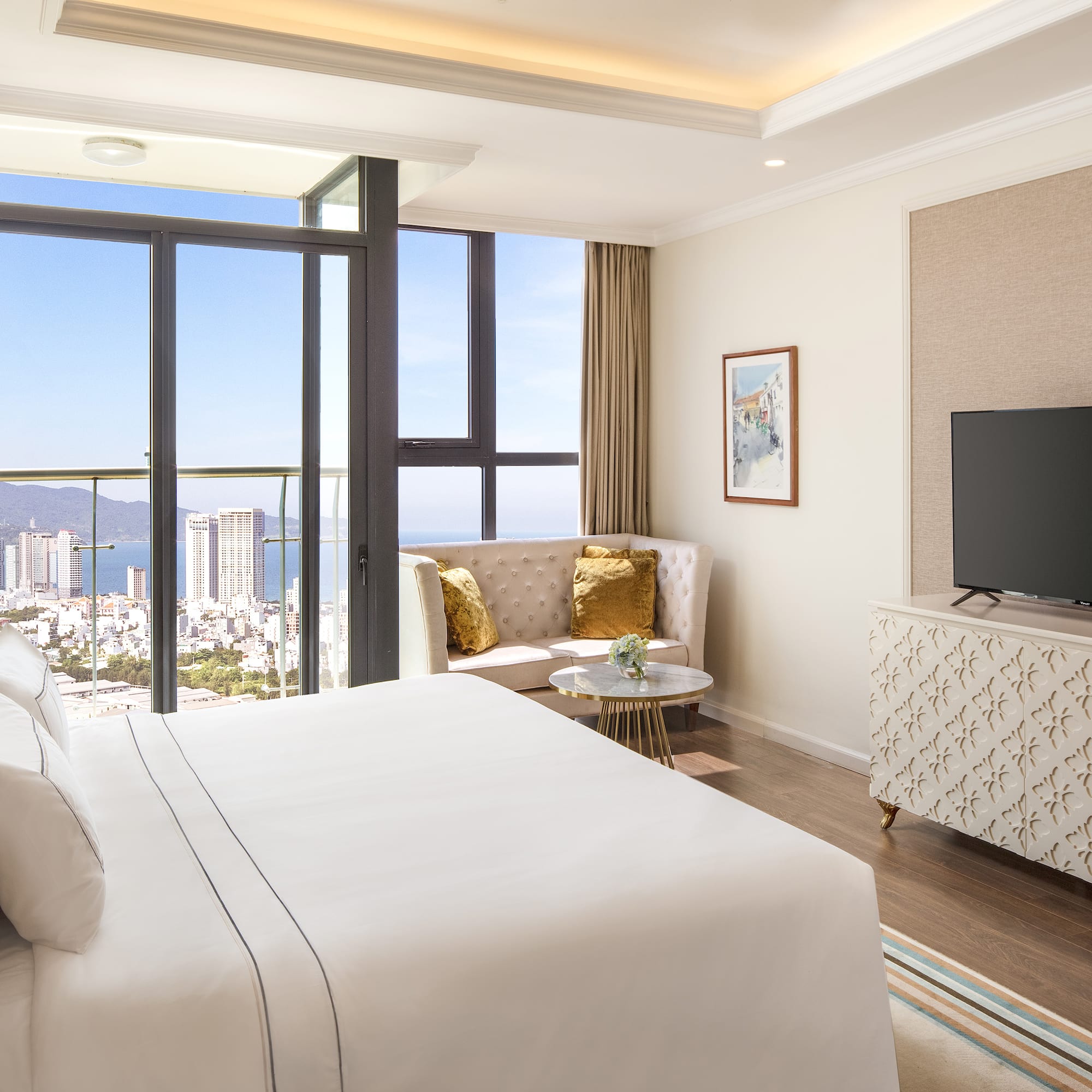 a bedroom with a television and a view of the city
