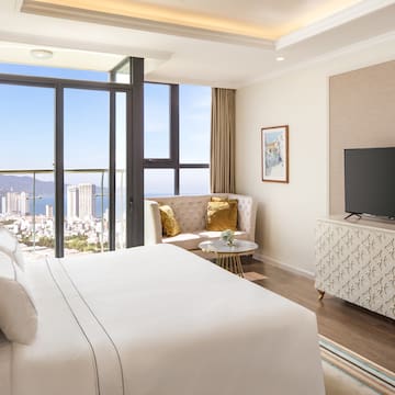 a bedroom with a television and a view of the city
