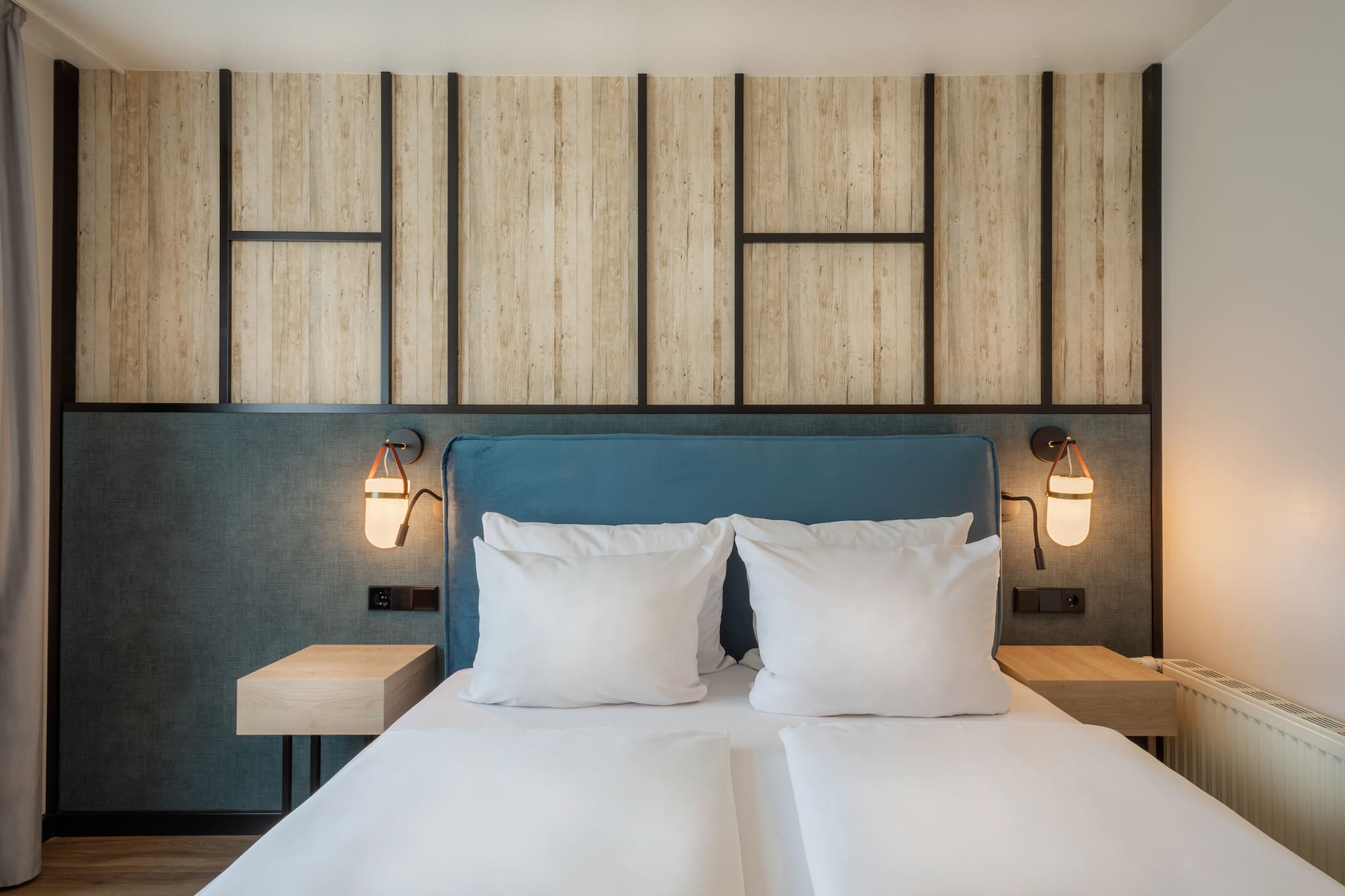 a bed with white pillows and a blue headboard