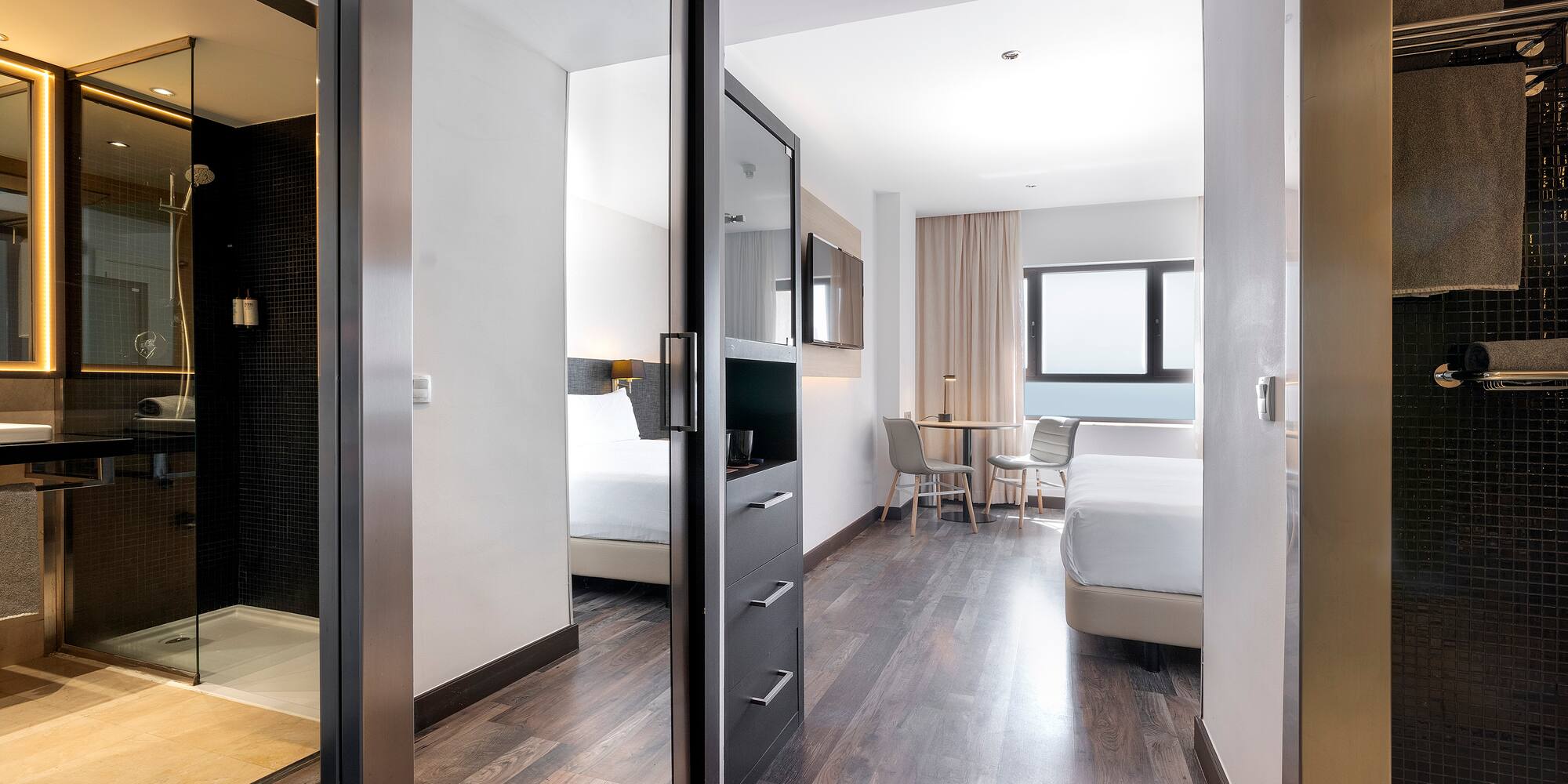 a room with a mirror door and a bed