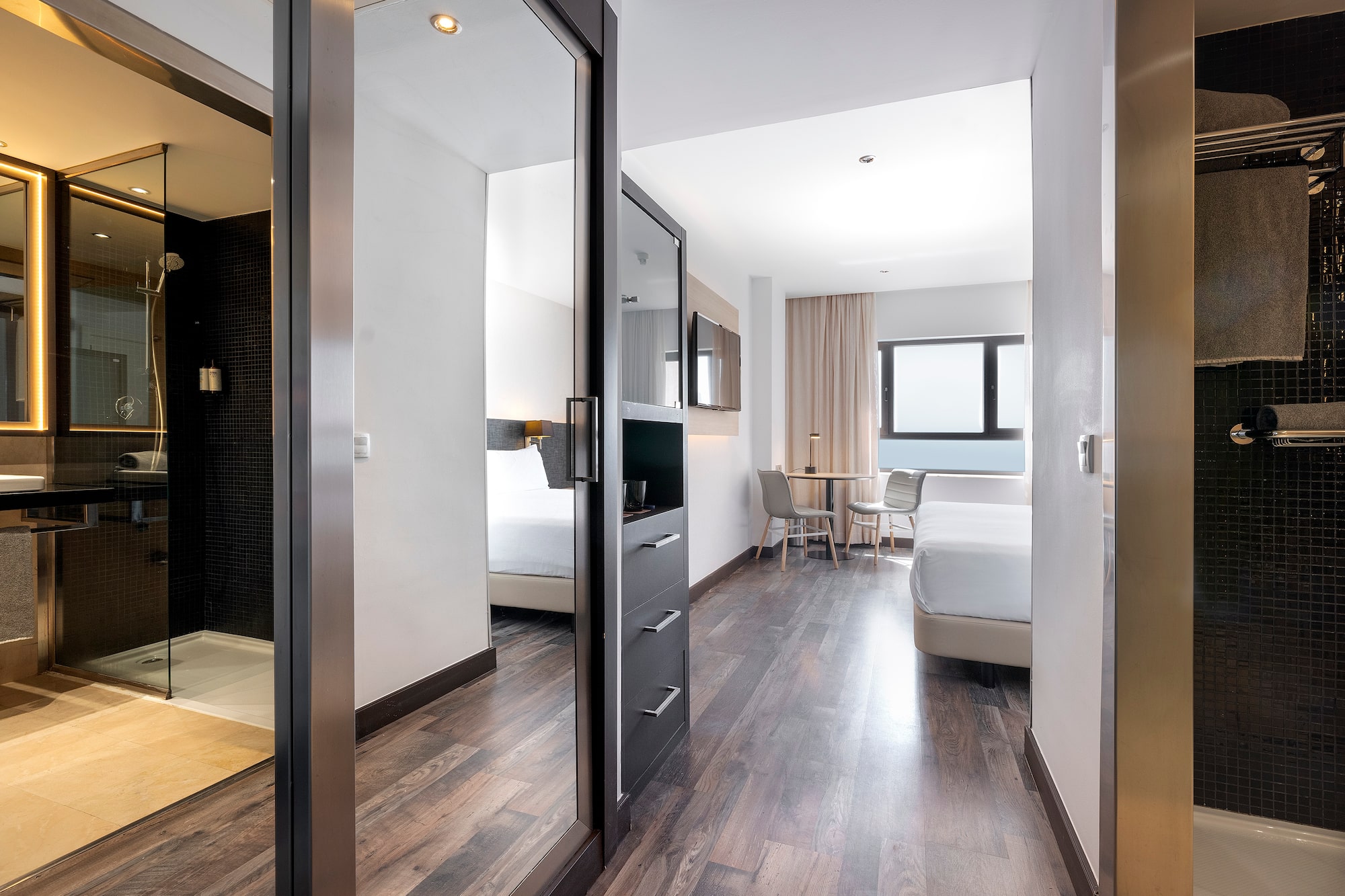 a room with a mirror door and a bed