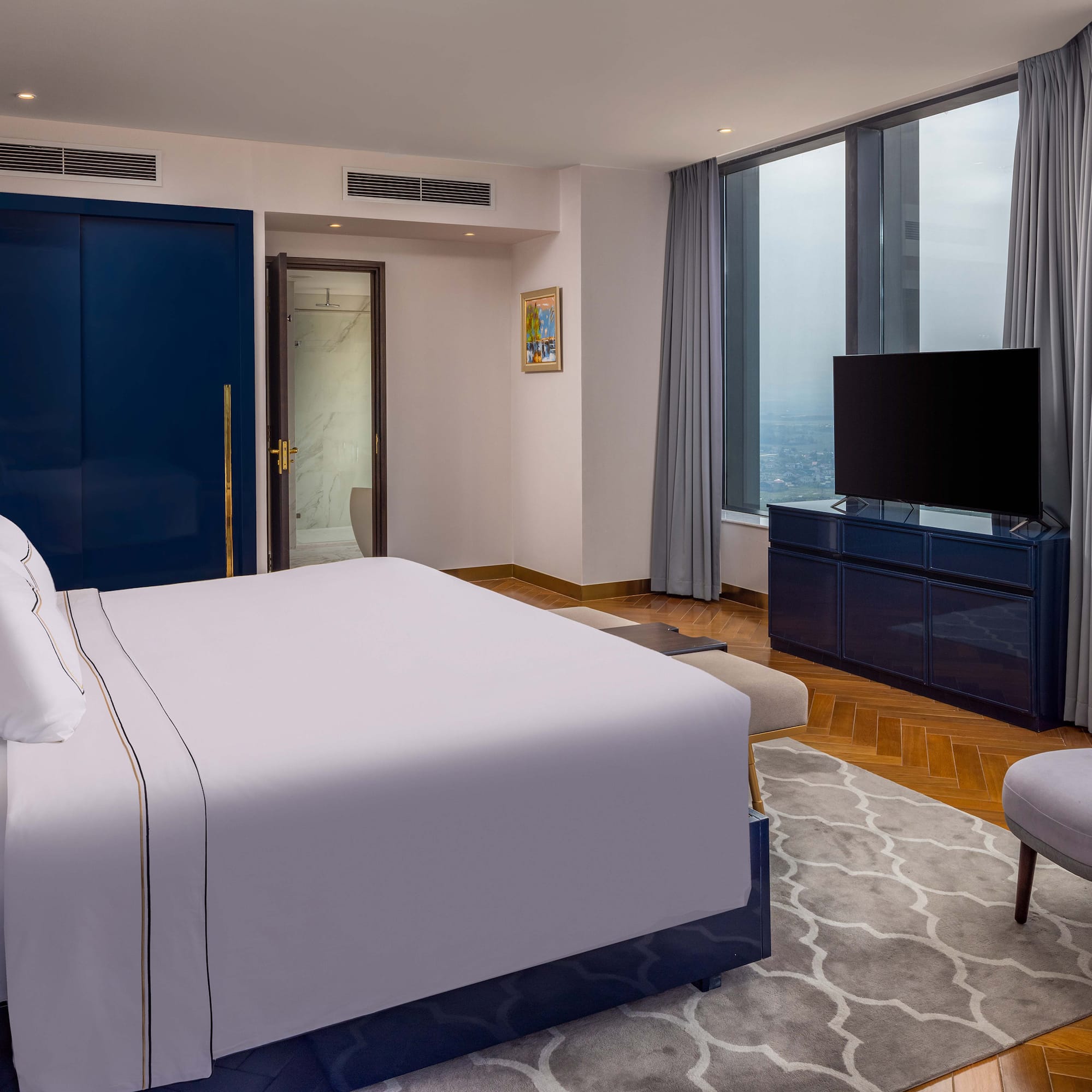 a bedroom with a large bed and a blue door