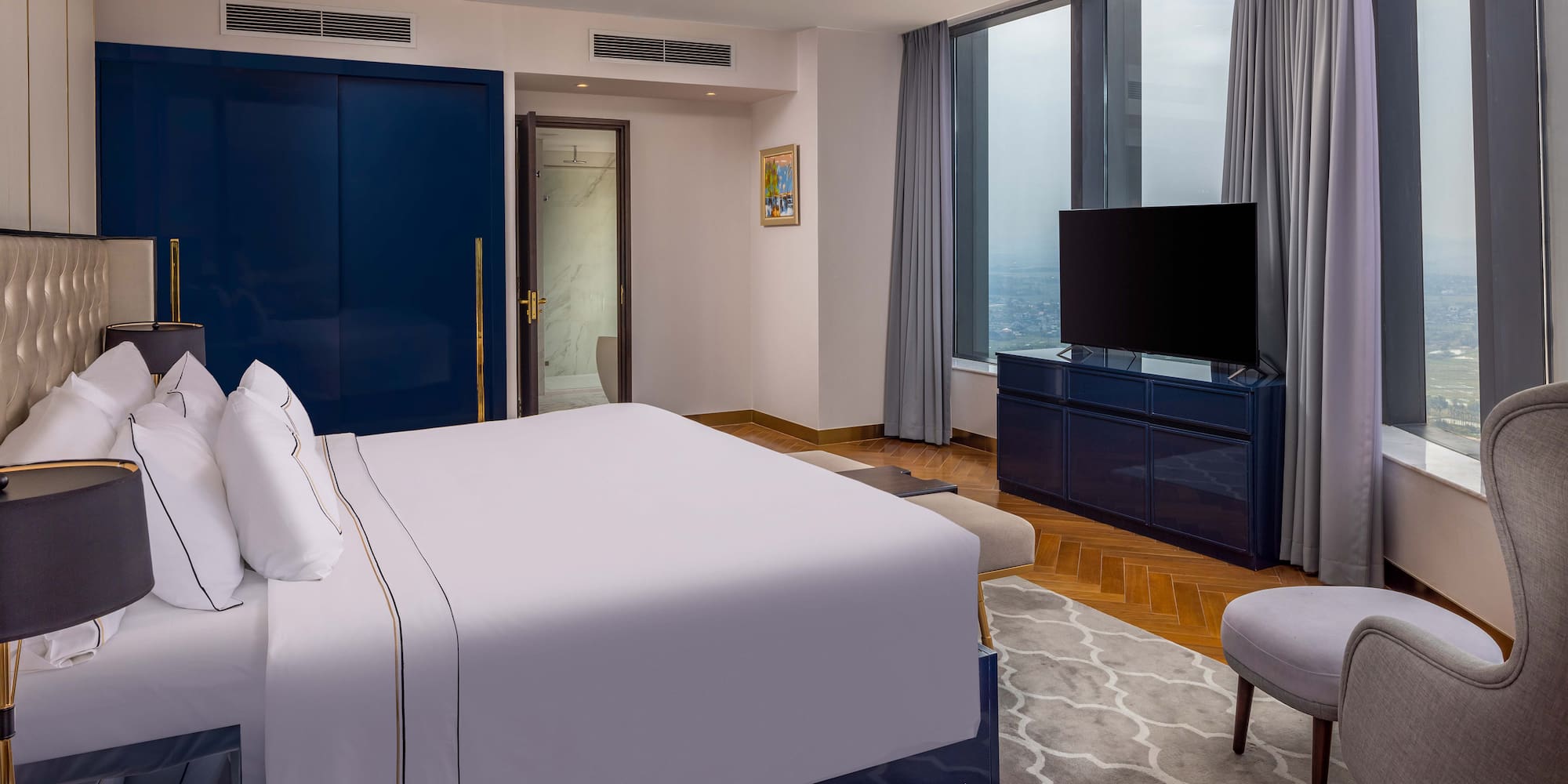 a bedroom with a large bed and a blue door