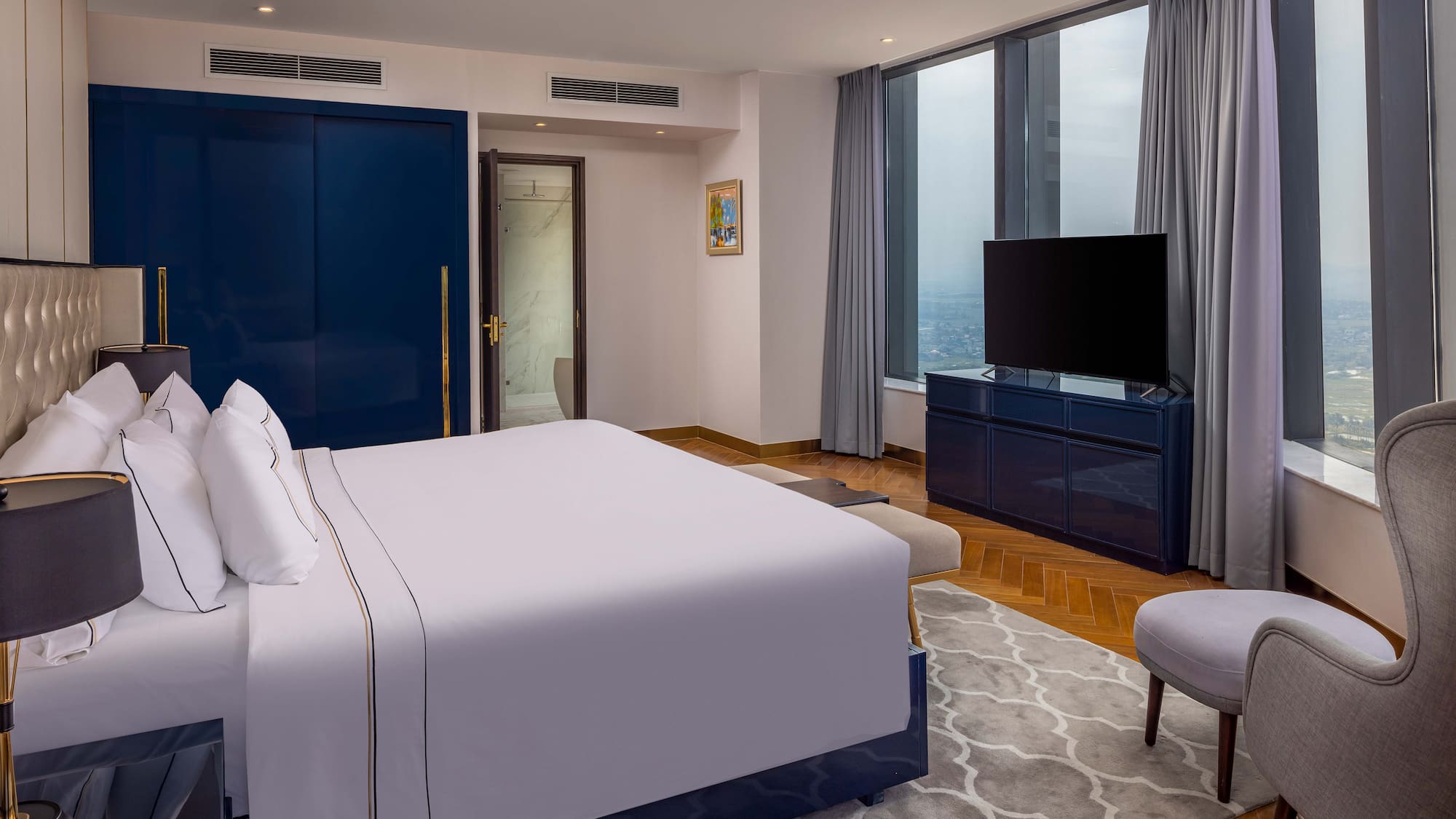 a bedroom with a large bed and a blue door