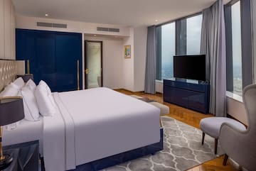 a bedroom with a large bed and a blue door