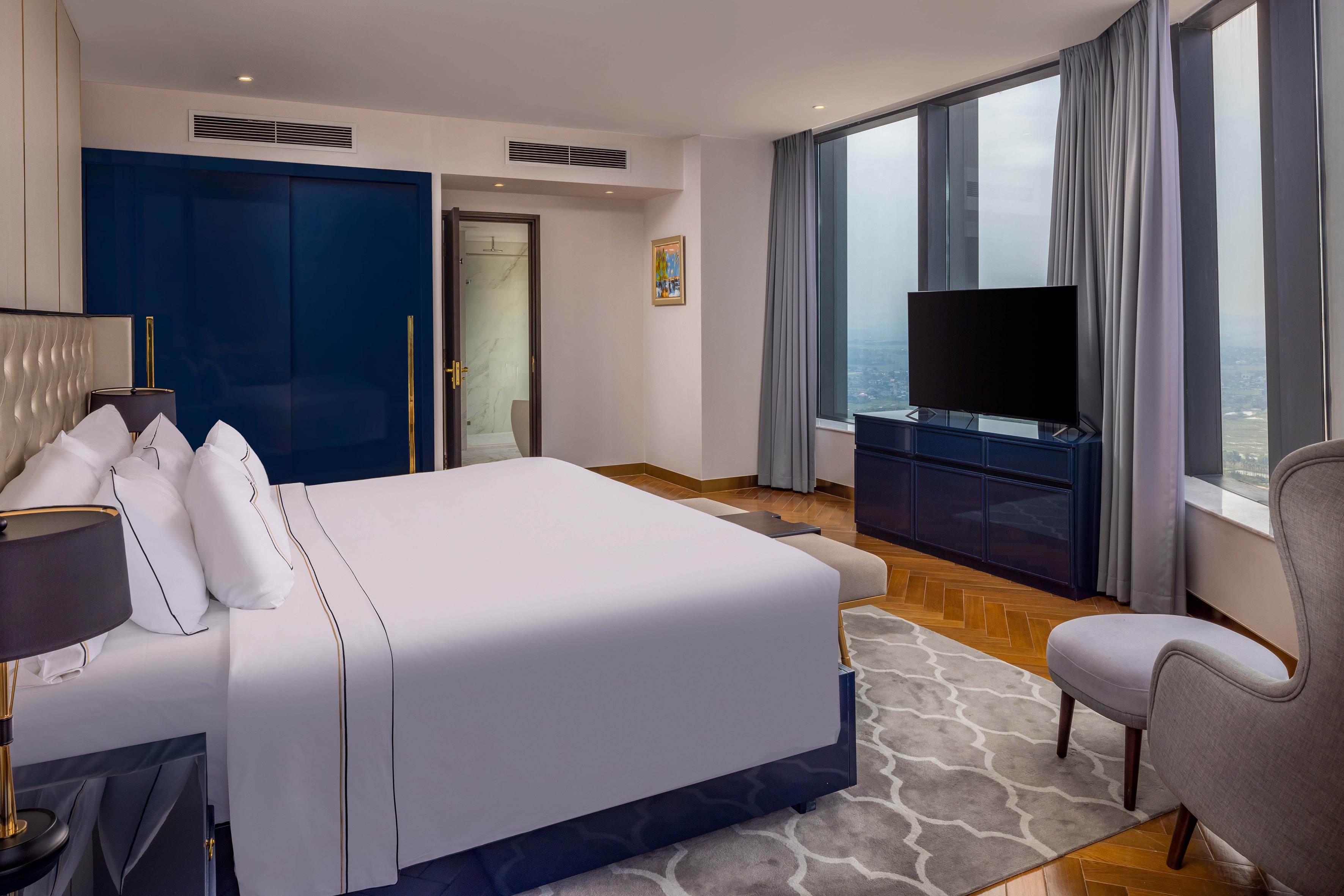 a bedroom with a large bed and a blue door