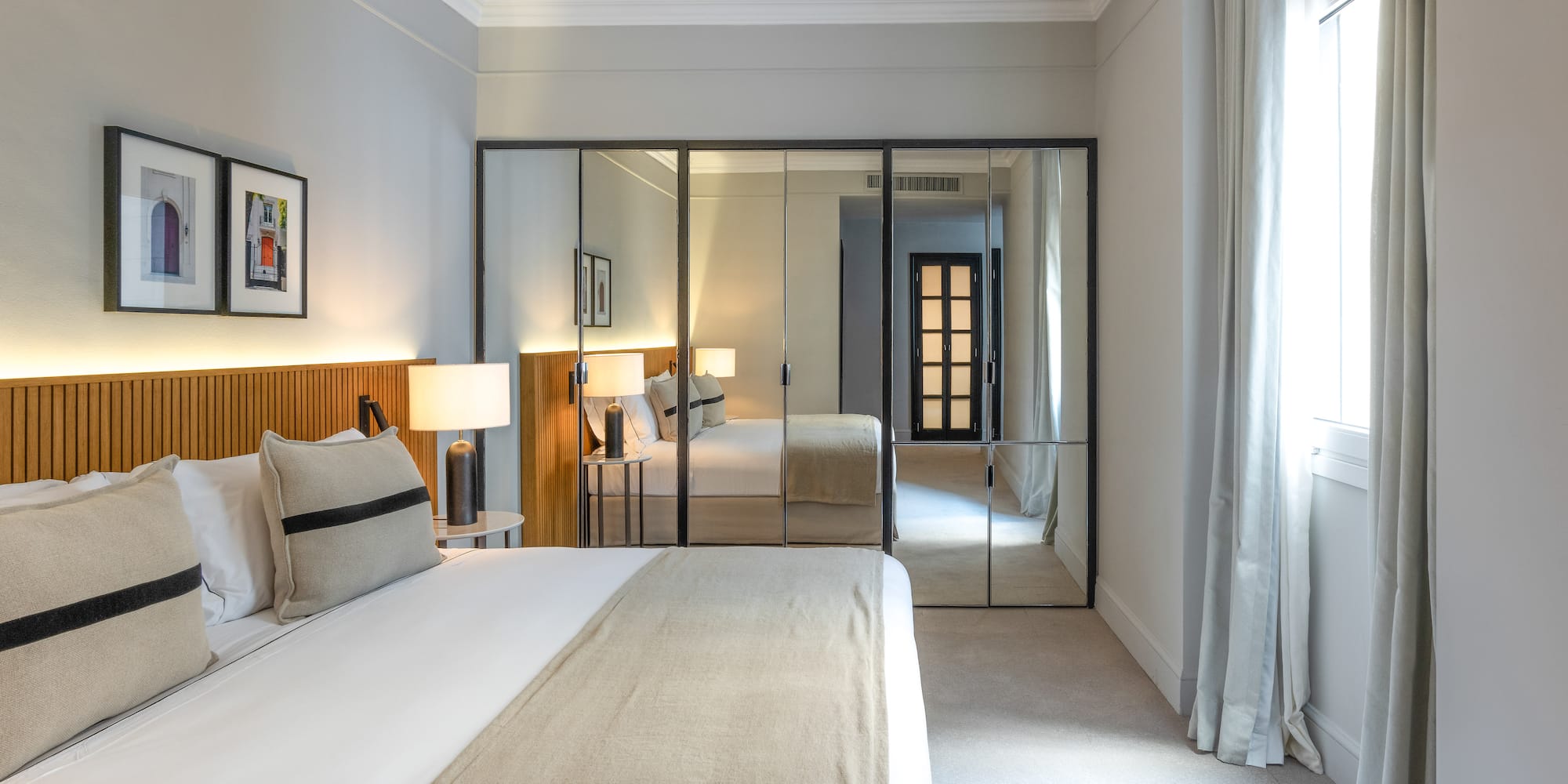 a bedroom with a bed and a mirror