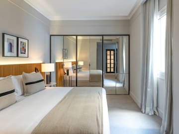 a bedroom with a bed and a mirror