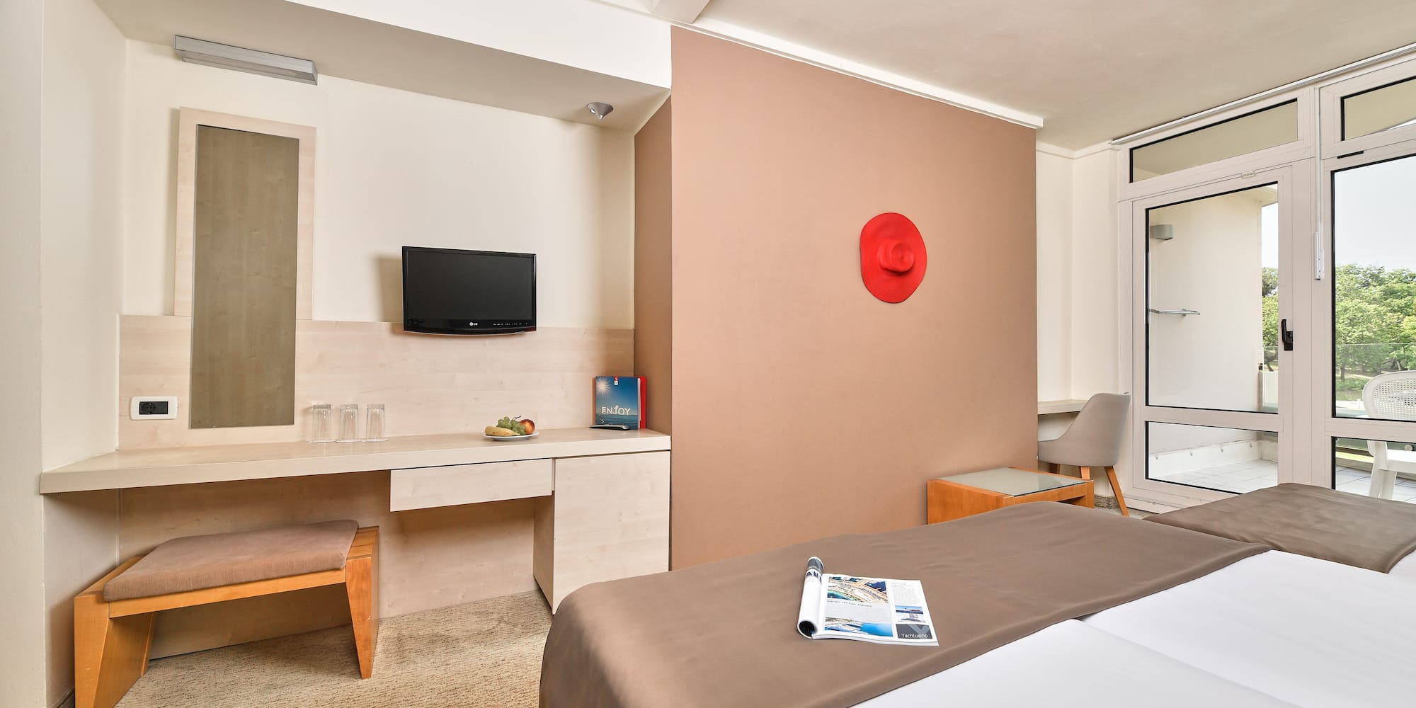 a room with a bed and a television