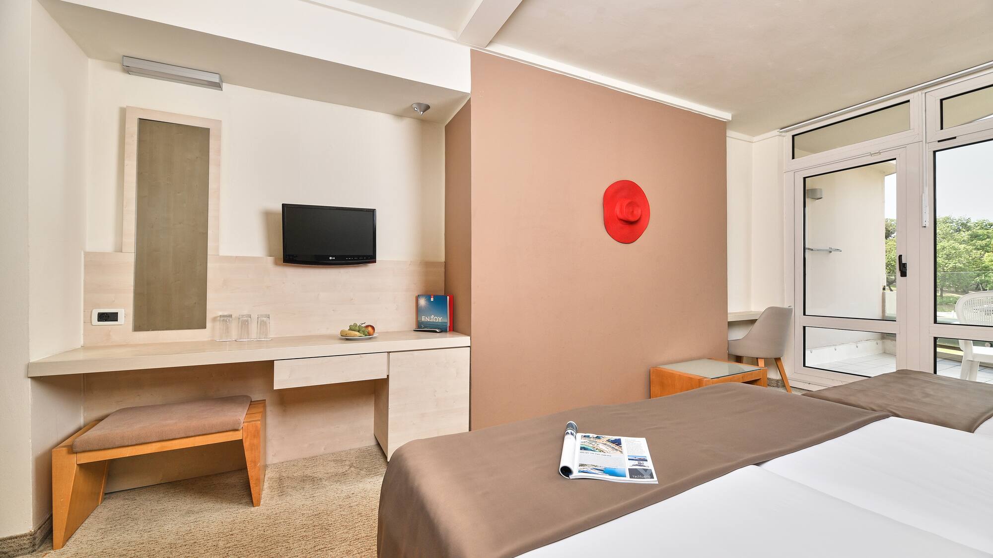 a room with a bed and a television