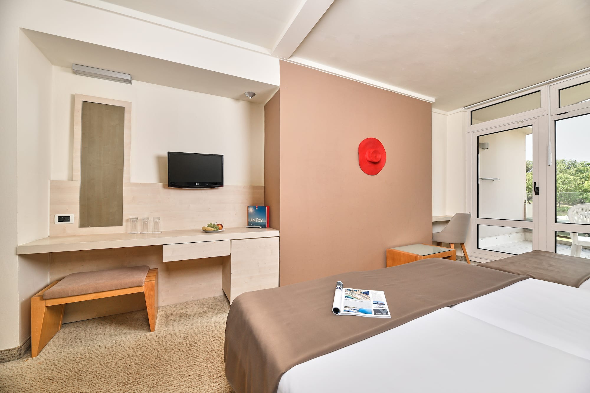 a room with a bed and a television